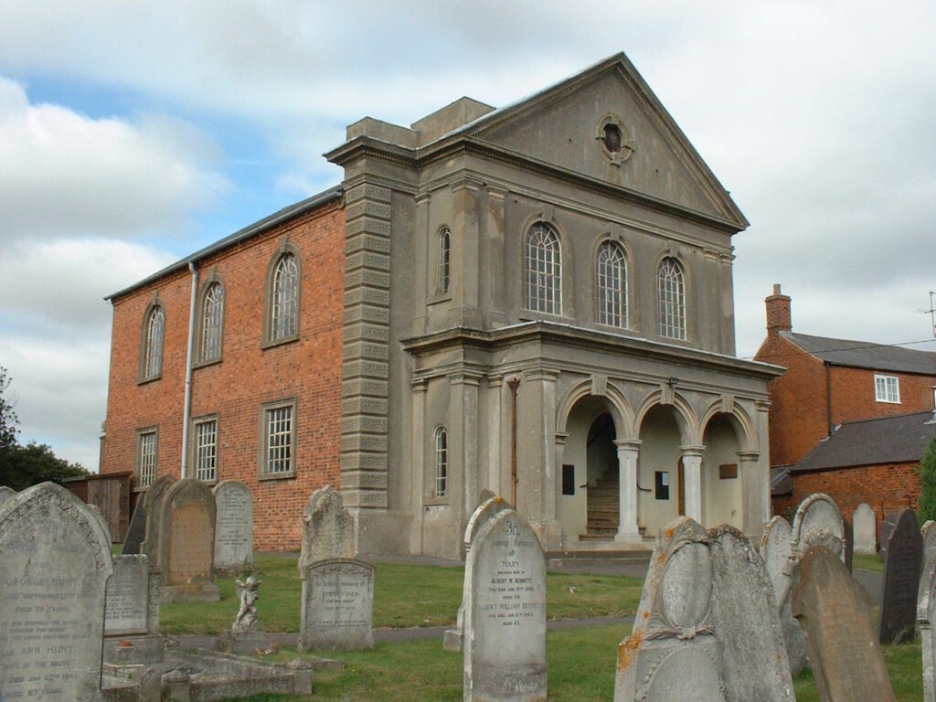 A large Victorian Baptist chapel with gravestones in the foreground.